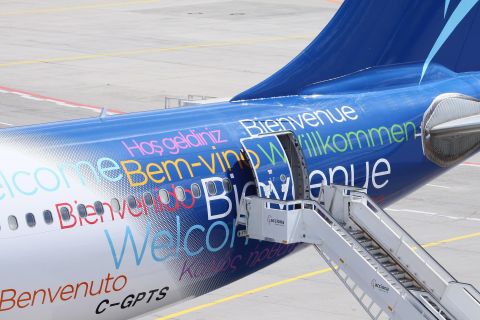 Airplane with "Welcome" in multiple languages