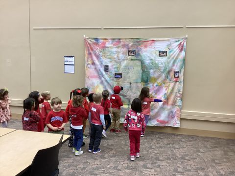 Kindergarten Prep class viewing artwork by Bright Horizons in the Lamar Soutter Library